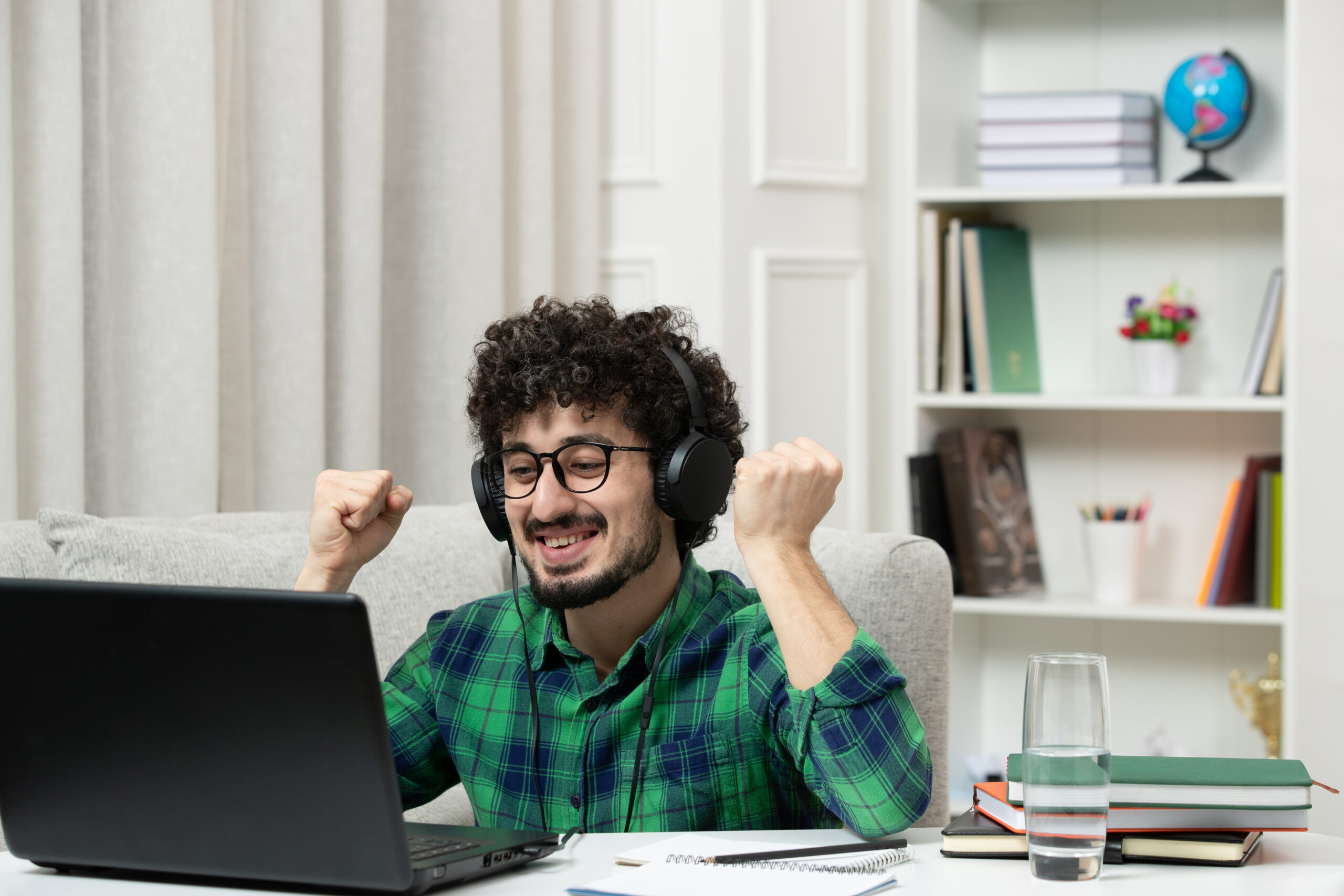 student-online-cute-young-guy-studying-computer-glasses-green-shirt-holding-fists-up